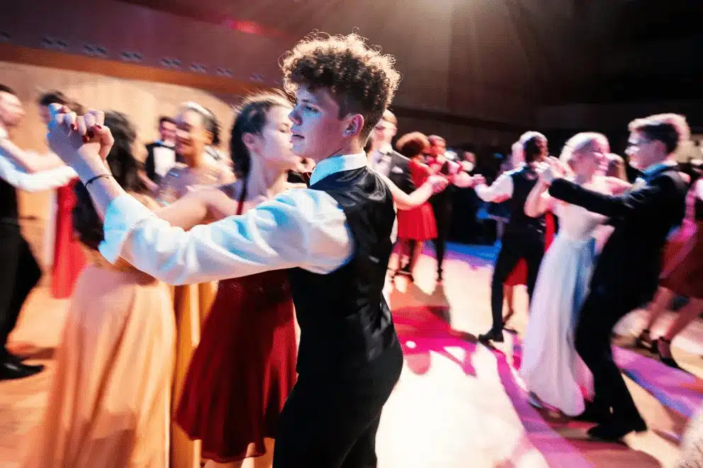 Young couple at prom - boy asking girl in wheelchair to dance